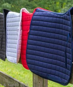 Horze Bristol AP saddle pads in fall 2018 colors hanging over fence post